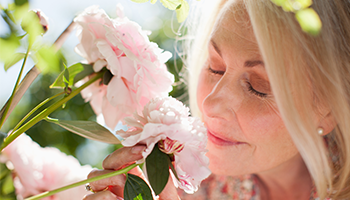 woman smelling flower